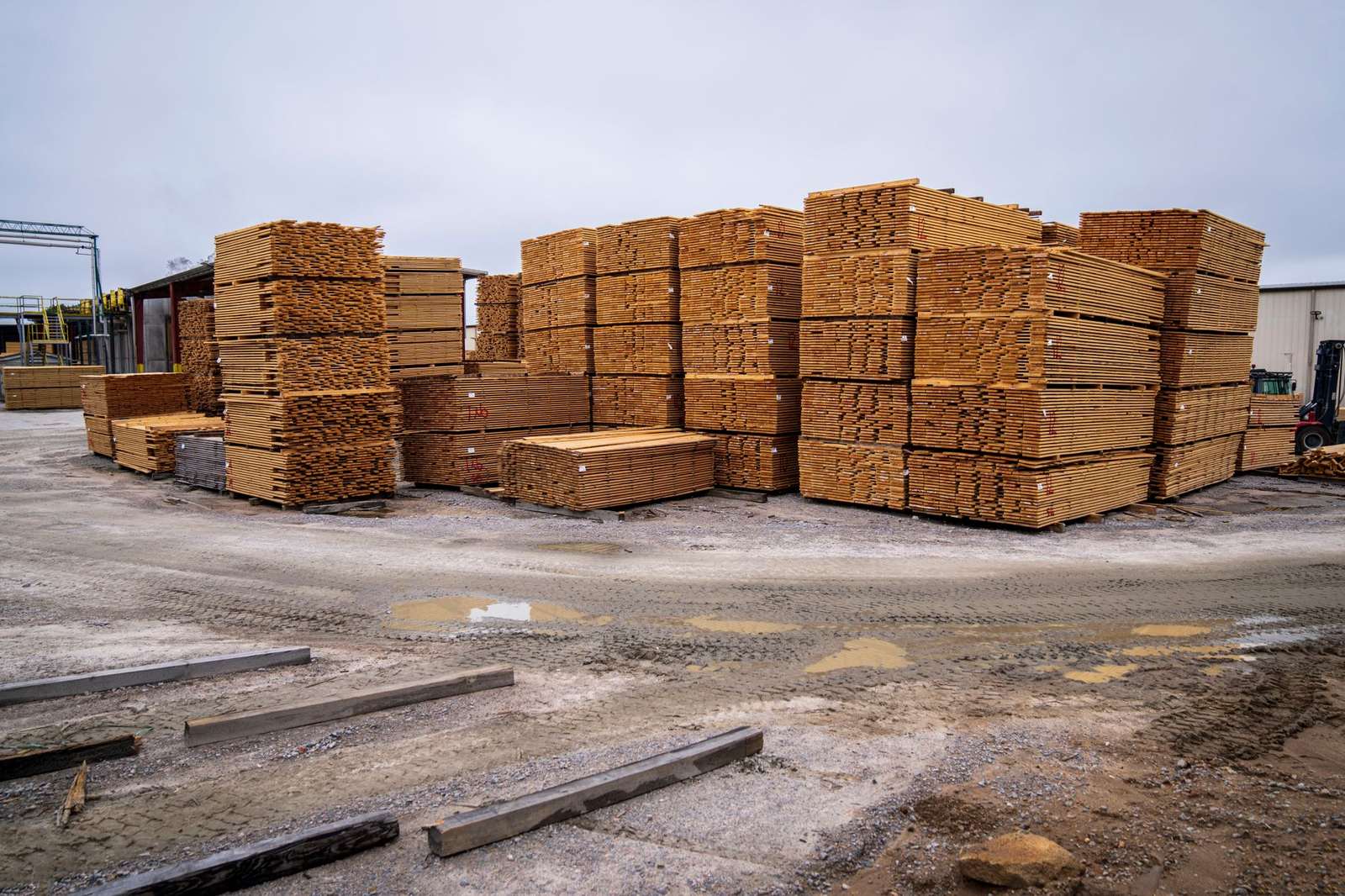 Piles of wooden planks prepared for distribution in an outdoor industrial site